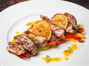 Grilled steak with roasted bell peppers and orange slices